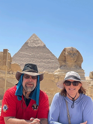 Ellen Asbury and her husband in front of the Sphinx and pyramids