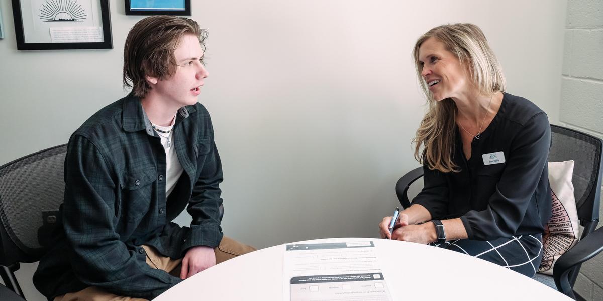 Student talking to counselor.