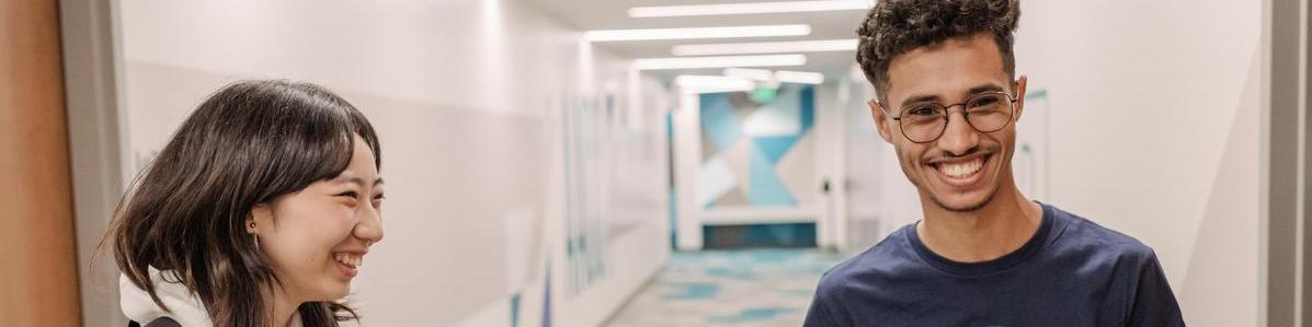 Students smiling and laughing while inside the Florestano building.
