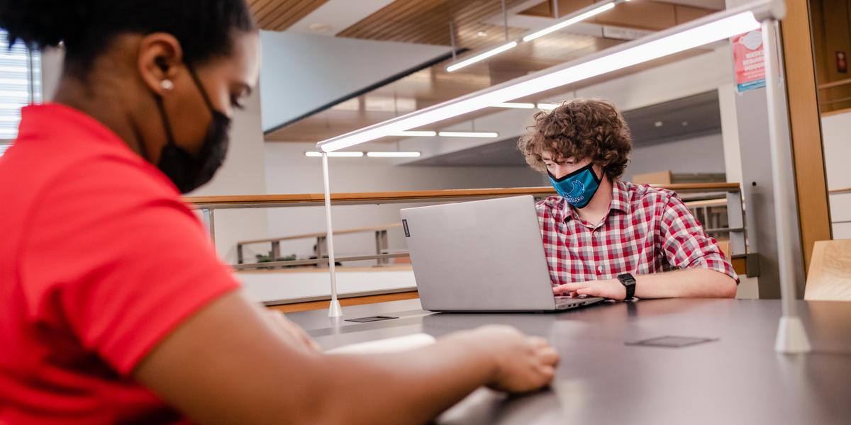 Students studying inside the AACC library.