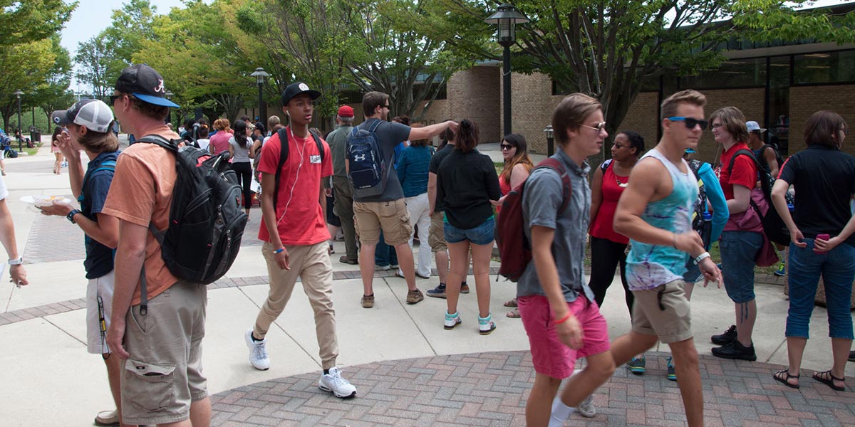 AACC students walking across a busy quad.