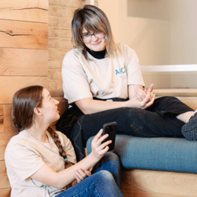 Students sitting on steps talking to one another