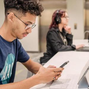 Student on phone and tablet