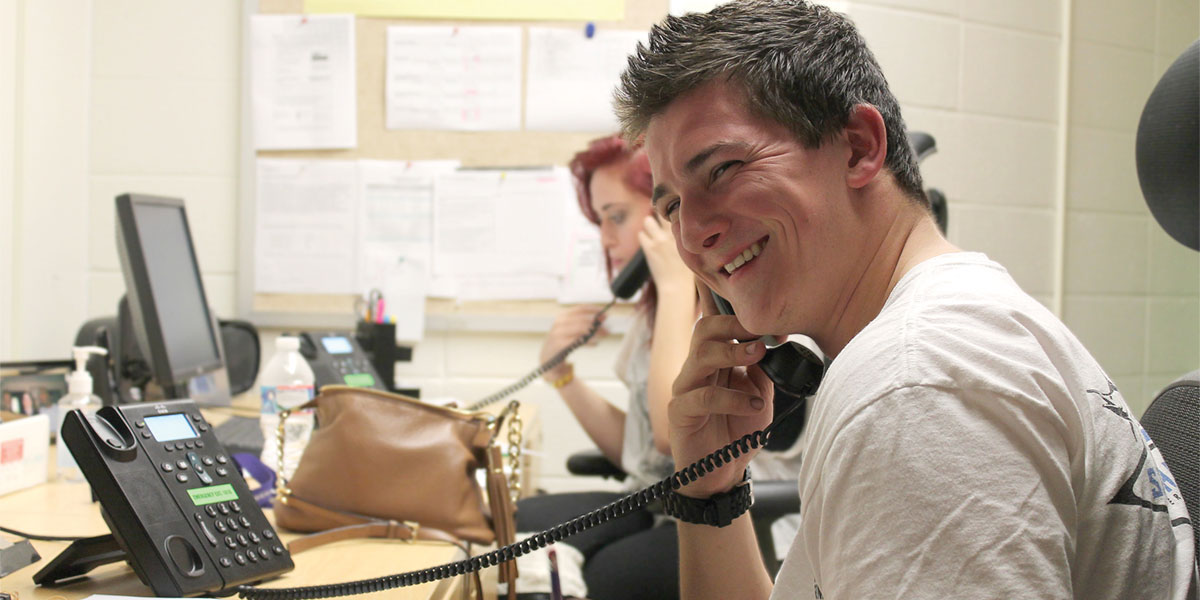 Student collecting data by telephone