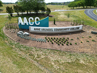 Aerial view of AACC sign at entrance of campus